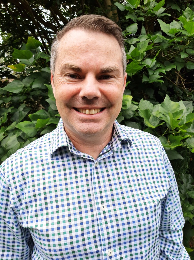 This image has an empty alt attribute; its file name is headshot.jpg